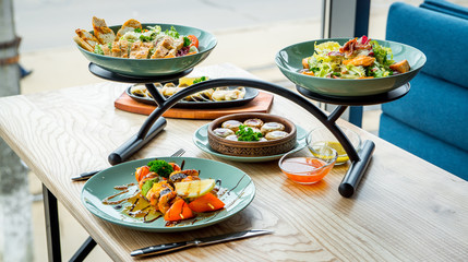 Different dishes on the table in a cafe, restaurant interior