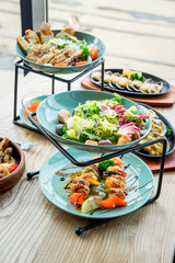 Different dishes on the table in a cafe, restaurant interior