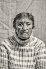 Black and white portrait of an old woman. Photographed close-up.