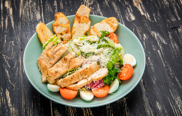Caesar salad with salmon and fresh vegetables. Top view.