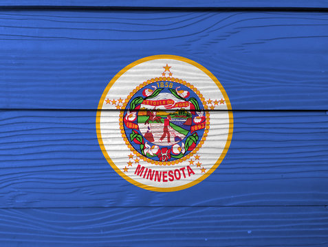 Minnesota flag color painted on Fiber cement sheet wall background. State seal on a medium blue field.