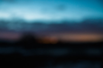 blurred blue sky at twilight with toptrees