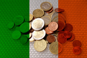 euro metal coins euro on the background of the national flag of ireland, the concept of financial development, devaluation, inflation, taxes