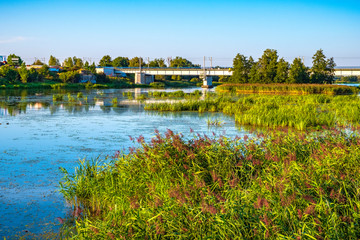 Panoramic view of the Nogat river with a railway bridge by the medieval Teutonic Order Castle in Malbork, Poland