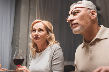 low angle view of woman with wine glass and man during dinner
