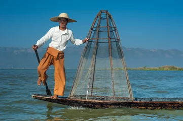 Foto op Canvas Burmese fisherman on bamboo boat catching fish. Myanmar © PerfectLazybones