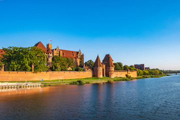 Panoramic view of the defense walls and towers of the Medieval Teutonic Order Castle in Malbork, Poland from across the Nogat river
