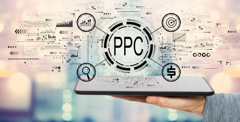 PPC - Pay per click concept with man holding a tablet computer