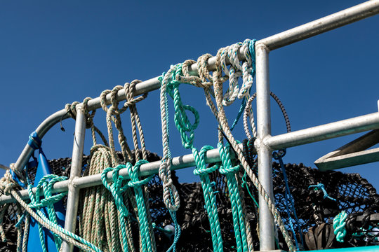 Ropes and Lobster Pots tiied to the railings gat St Brelade, Jersey, Channel Islands