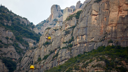 Yellow cable car in the Aeri de Montserrat rise to de Montserrat Abbey near Barcelona, Spain, Catalonia.