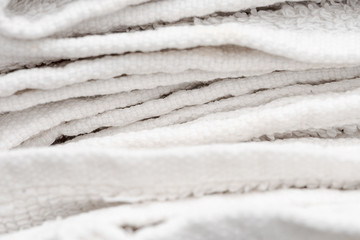Close up of sloppily folded white bathroom towels