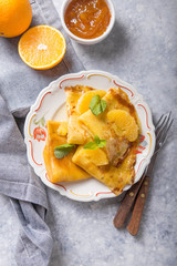 Traditional French crepe Suzette with orange sauce . top view, flat lay, copy space