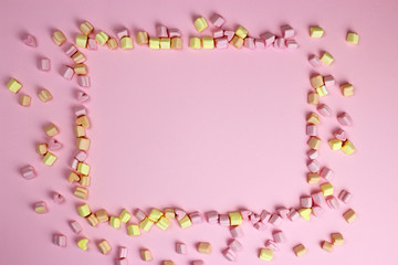 Fototapeta na wymiar Marshmallow frame, pink background. Valentine's day, lovers, wedding. Space for text