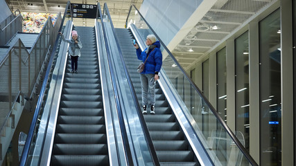 Mother and child together on escalator background. Terminal, airport travel, love care.