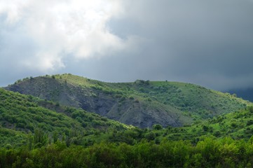 Fototapeta na wymiar Mountain ranges covered with forest and bushes