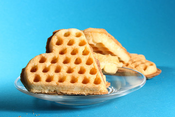Homemade cookies in a transparent glass plate on a turquoise background