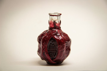 decorative bottle of red pomegranate wine