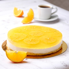 Homemade delicious sweet passion fruit orange cake, mousse dessert on cup of coffee americano, white background. Organic dessert sugarless. Healthy eating.