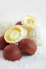 Coconut candy with nuts and chocolate isolated on a white background.