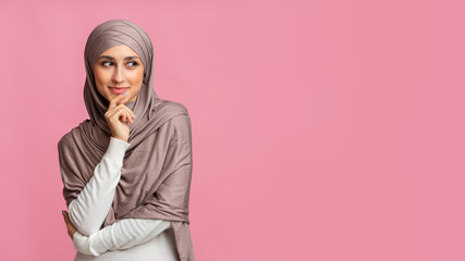 Portrait of thoughtful muslim girl looking aside at copy space