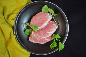 Raw meat in a pan with herbs.Steak.