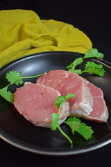 Raw meat in a pan with herbs.Steak.