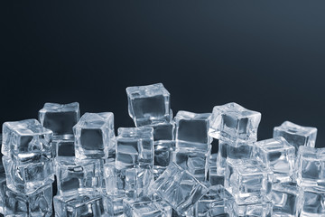 Crystal clear ice cubes on black background