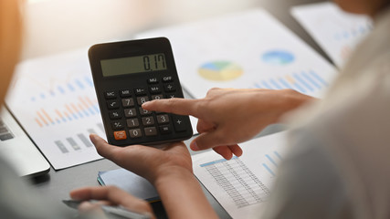 Close-up image of young business development team are calculating /discussing/brainstorming at the...