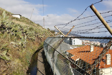 levada with Barbed Wire and and look at the atlantic ocean in Funchal at madeira island