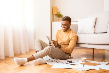 Happy Student Using Tablet Studying Sitting On Floor At Home