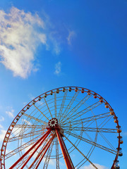 Fototapeta premium Partly visible ferris wheel with soft clouds