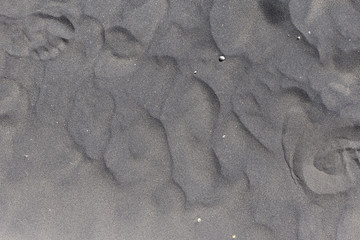 Beautiful dark beige glitter sand pattern left after ocean water. Canarian island