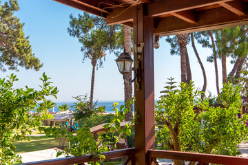 Beautiful view of the tropical garden and the sea on a sunny day from the hotel veranda