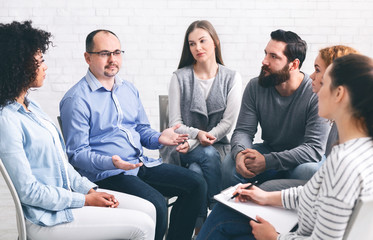 Man sharing his story, telling about problems at group therapy session
