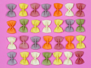 Dried colorful Italian pasta farfalle or bows background