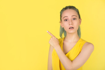 beautiful young woman in a yellow dress on a yellow background