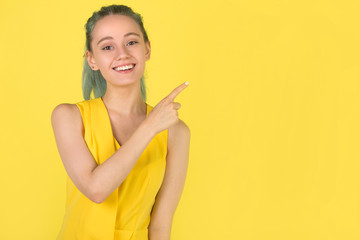 beautiful young woman in a yellow dress on a yellow background