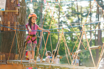 Obraz na płótnie Canvas little girl getting ready for climbing