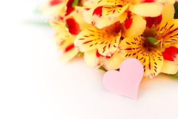 A small pink heart with a place for text decorated with a yellow flowers on a white background