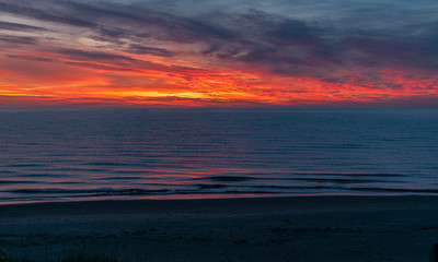 Fototapeta na wymiar sea sunset landscape with colorful skies and dark water