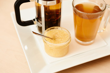 Tea with a teapot, cup and lemon jam. Natural fruit tea.
