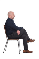 portrait of a man sitting on a chair in white background, profile