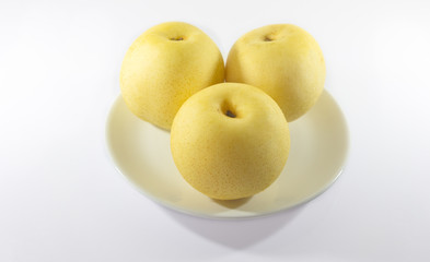 Asian pear or Nashi pear on plate. White background