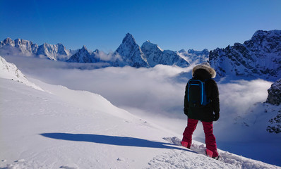 COPY SPACE: Snowboarder observes snowy ridge before shredding the fresh snow.