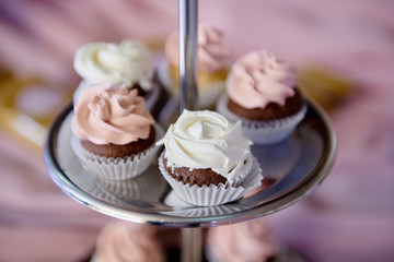 Candy bar served with cupcakes in pink color, copy space. Dessert table for a party. Holiday concept
