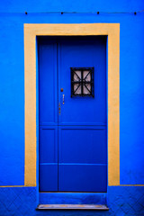 Front view of an access door to a house, blue and yellow colors