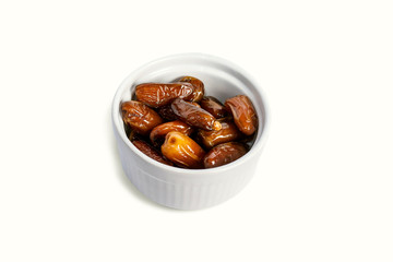 Bowl of dried dates isolated on white background