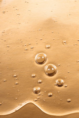 Hyaluronic acid gel. Textured background with oxygen bubbles on silver background.