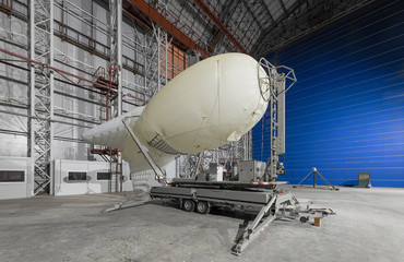 Aerostat on a mobile mooring platform inside an big airship hangar