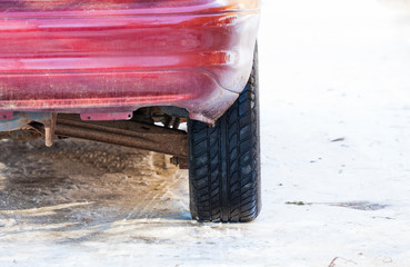 back of car with tire in the snow.
